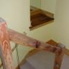 Re-use of timber framing for wood and glass stair rail with mirrored art niche beyond